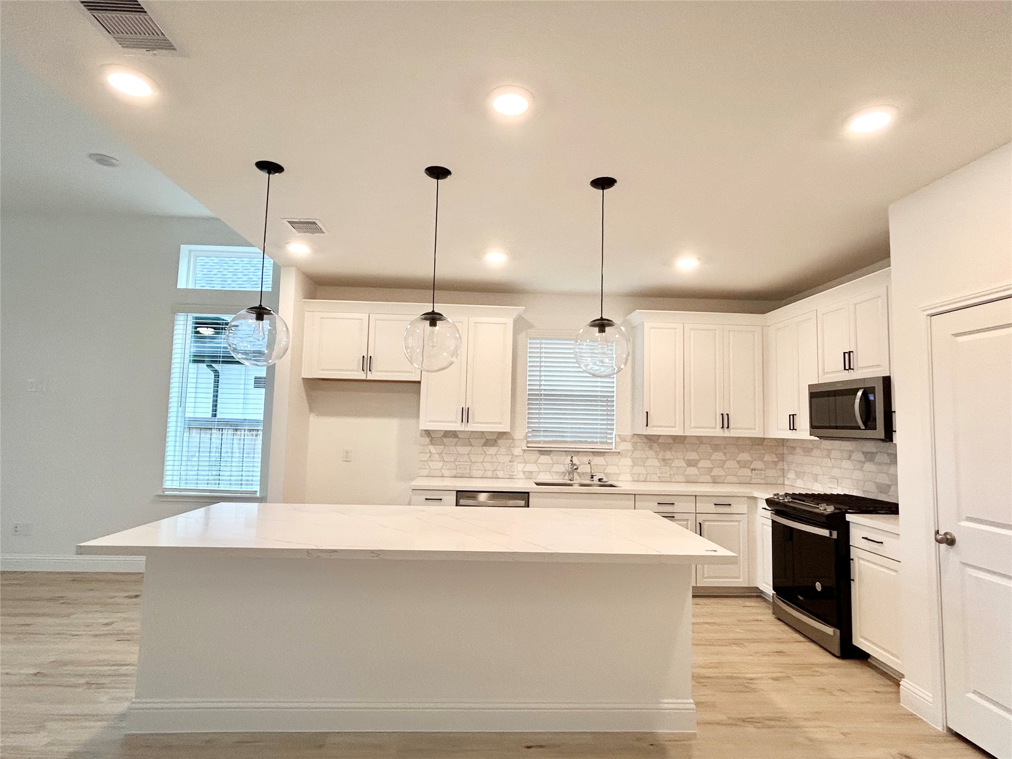 15310 Spanish Ranchos Way, Unit WAYS Cypress, TX 77433 - Photo 11 of 40 Kitchen with white cabinets