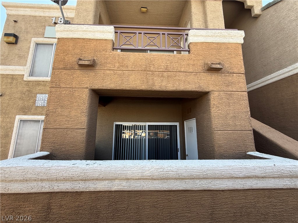 8070 West Russell Road, Unit 1092 Las Vegas, NV 89113 - Photo 1 of 14 Multi-level stucco exteriors feature private covered outdoor spaces and sliding glass doors.