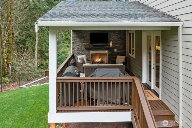 a view of backyard with deck and outdoor seating