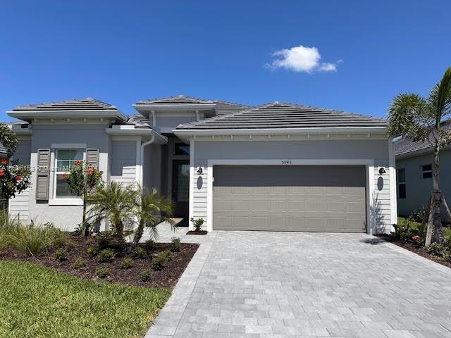 5545 Hampton Links Court, Unit 5545 Ave Maria, FL 34142 - Photo 1 of 28 a view of a house with potted plants and a table and chairs