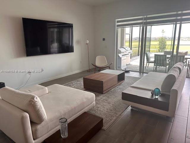 5545 Hampton Links Court, Unit 5545 Ave Maria, FL 34142 - Photo 12 of 28 a living room with furniture and a flat screen tv