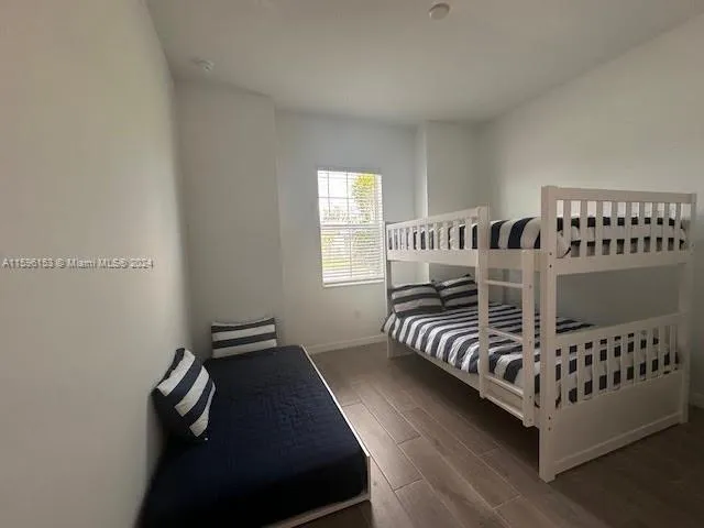 a bedroom with bed and window