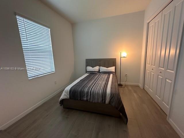 5545 Hampton Links Court, Unit 5545 Ave Maria, FL 34142 - Photo 20 of 28 a bed room with a bed and a night stand