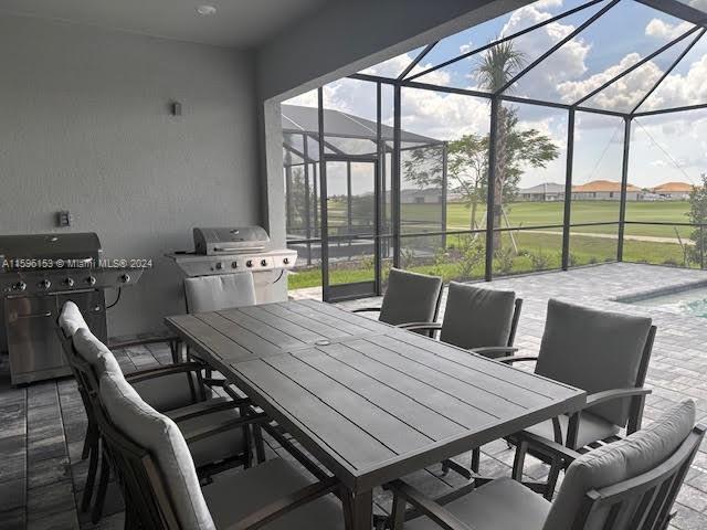 5545 Hampton Links Court, Unit 5545 Ave Maria, FL 34142 - Photo 22 of 28 a outdoor dining space with furniture and outdoor view
