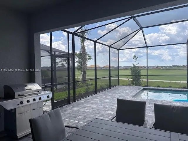 a bed sitting in a room next to a large window