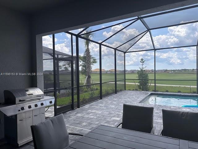 5545 Hampton Links Court, Unit 5545 Ave Maria, FL 34142 - Photo 23 of 28 a bed sitting in a room next to a large window