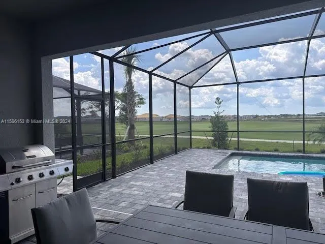 a living room with furniture and floor to ceiling windows