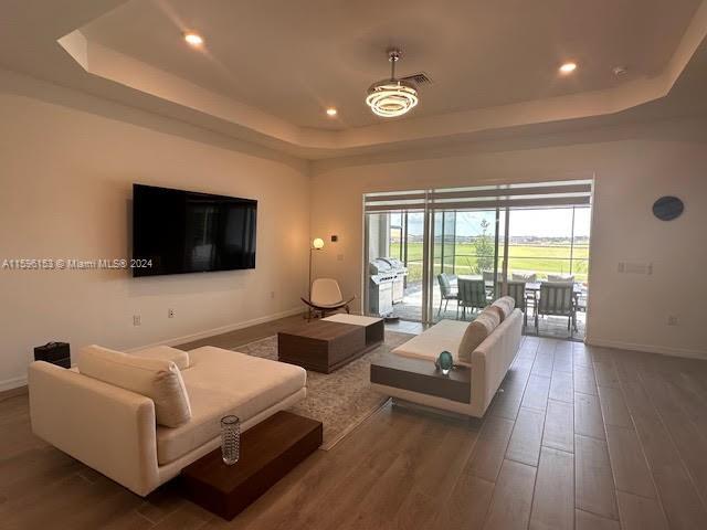 5545 Hampton Links Court, Unit 5545 Ave Maria, FL 34142 - Photo 6 of 28 a living room with furniture and a flat screen tv