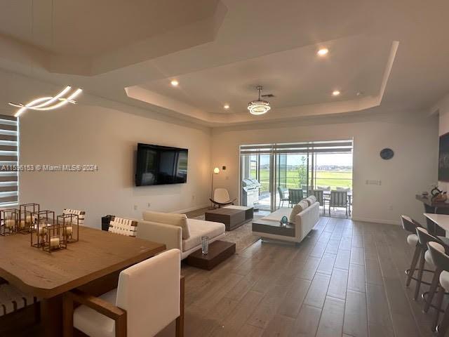 5545 Hampton Links Court, Unit 5545 Ave Maria, FL 34142 - Photo 8 of 28 a living room with furniture and a flat screen tv