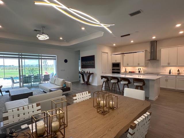 5545 Hampton Links Court, Unit 5545 Ave Maria, FL 34142 - Photo 9 of 28 a large kitchen with a table and chairs