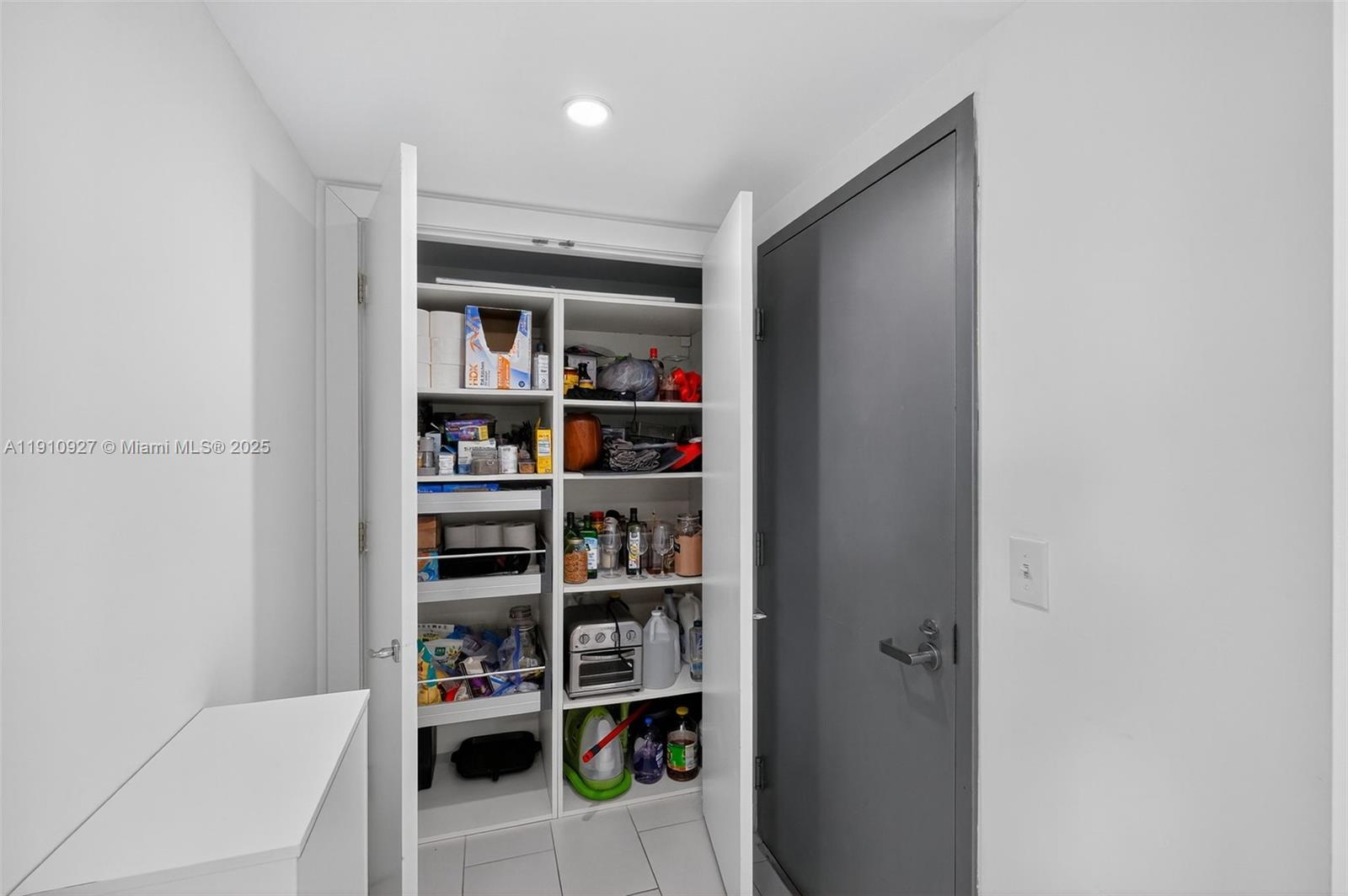 720 Northeast 62nd Street, Unit 311 Miami, FL 33138 - Photo 23 of 39 a room with a book shelf