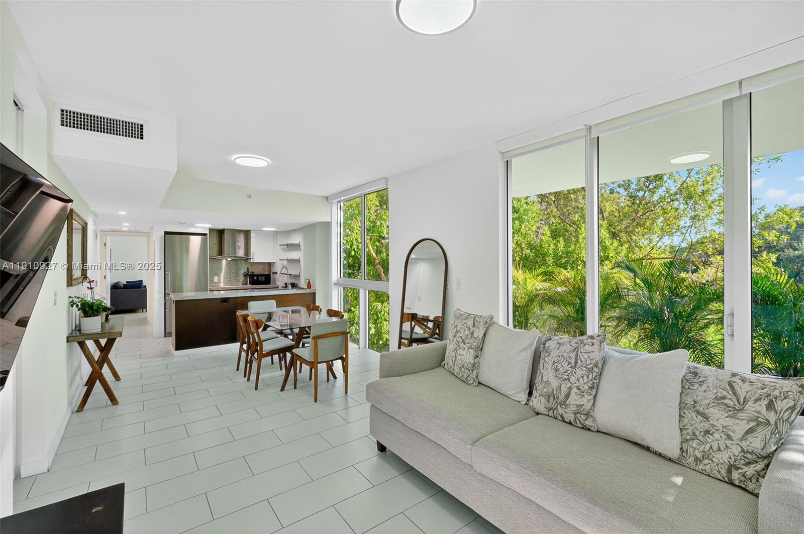 720 Northeast 62nd Street, Unit 311 Miami, FL 33138 - Photo 7 of 39 a living room with furniture and a large window