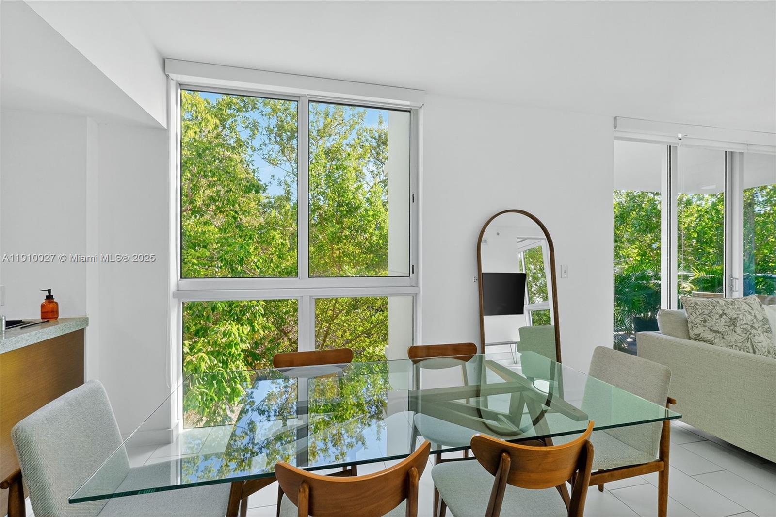 720 Northeast 62nd Street, Unit 311 Miami, FL 33138 - Photo 8 of 39 a view of a dining room with furniture window and outside view