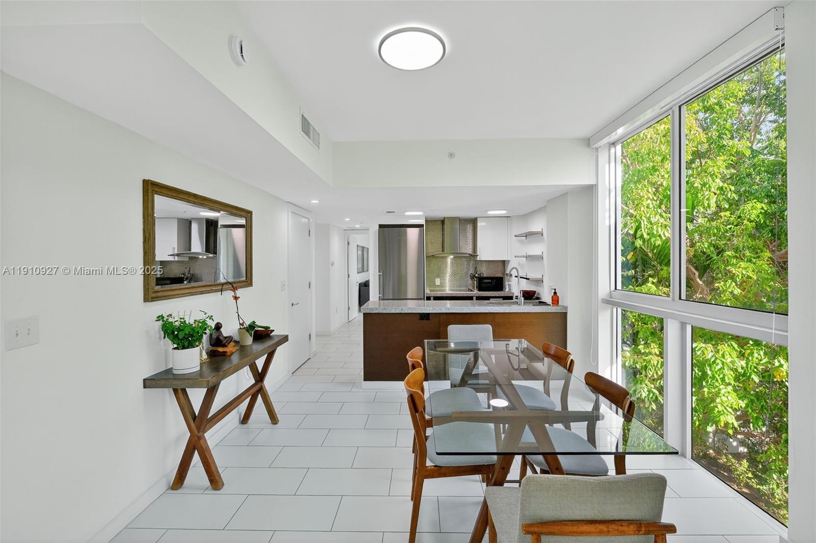 720 Northeast 62nd Street, Unit 311 Miami, FL 33138 - Photo 10 of 39 a view of a livingroom with furniture wooden floor and a rug