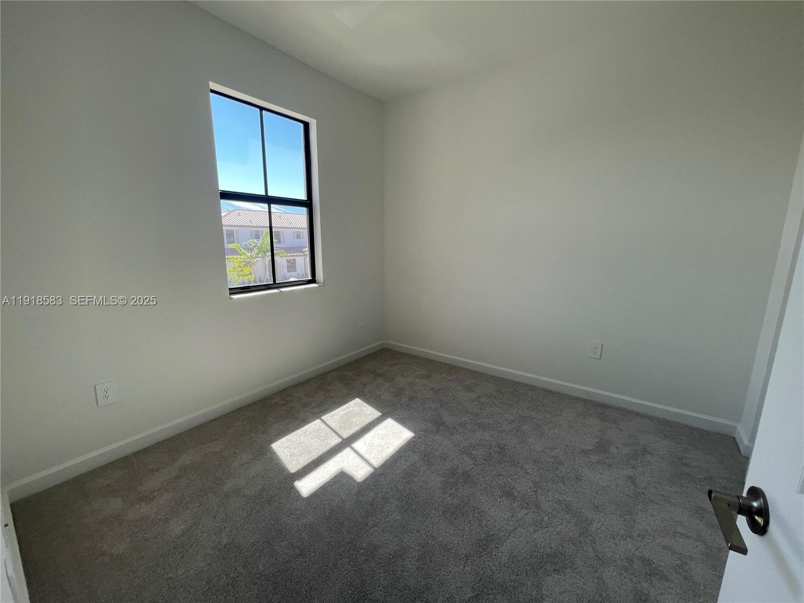 11745 Southwest 245 Terrace Homestead, FL 33032 - Photo 7 of 15 an empty room with windows