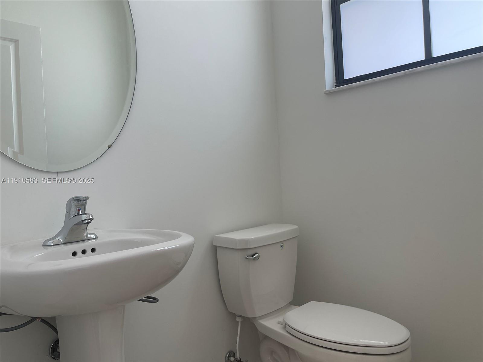 11745 Southwest 245 Terrace Homestead, FL 33032 - Photo 9 of 15 a bathroom with a sink mirror and toilet