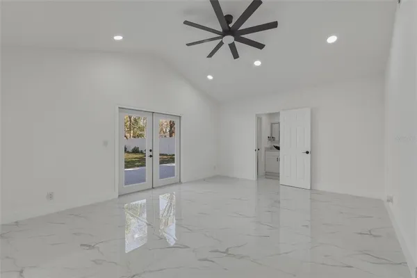 a view of an empty room with a fan