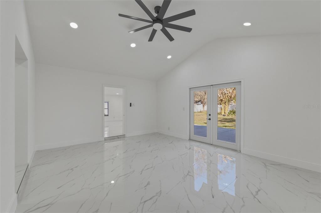 1413 May Street Lutz, FL 33548 - Photo 16 of 43 an empty room with windows and ceiling fan