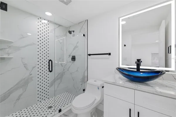 a bathroom with a sink toilet and shower