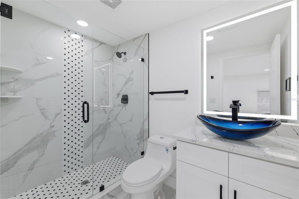 1413 May Street Lutz, FL 33548 - Photo 19 of 43 a bathroom with a sink toilet and shower
