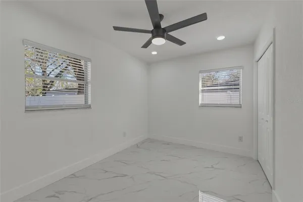 en empty room with wooden floor and window