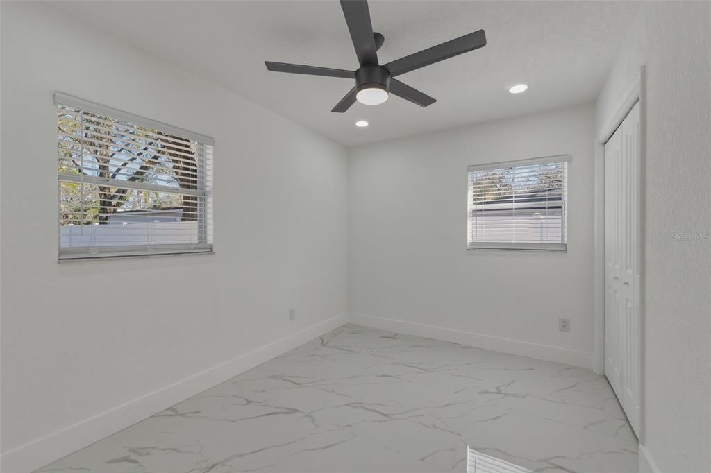 1413 May Street Lutz, FL 33548 - Photo 21 of 43 en empty room with wooden floor and window
