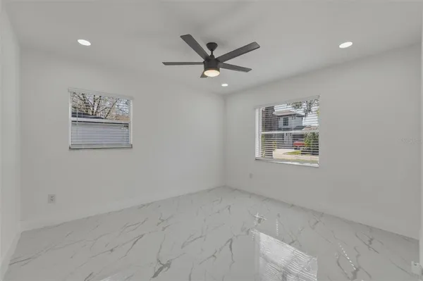 a view of a livingroom with a ceiling fan and window