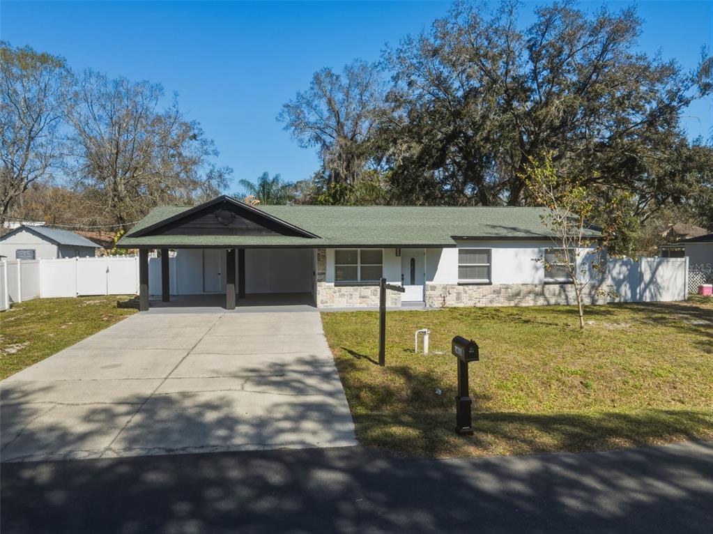 1413 May Street Lutz, FL 33548 - Photo 3 of 43 a front view of a house with a yard