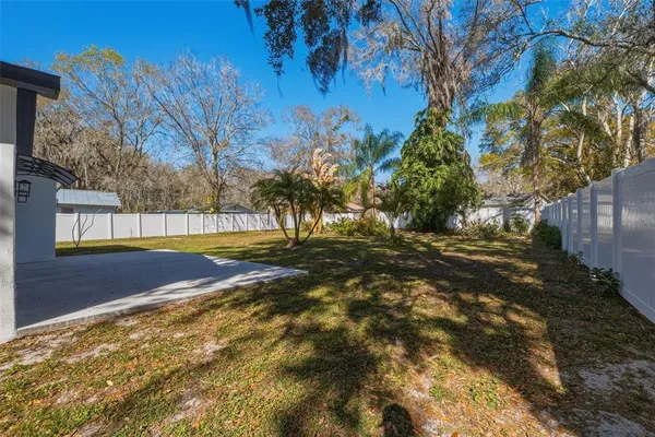 a view of swimming pool with large trees