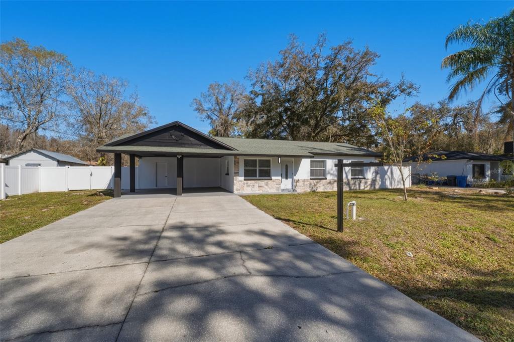 1413 May Street Lutz, FL 33548 - Photo 5 of 43 a front view of a house with swimming pool