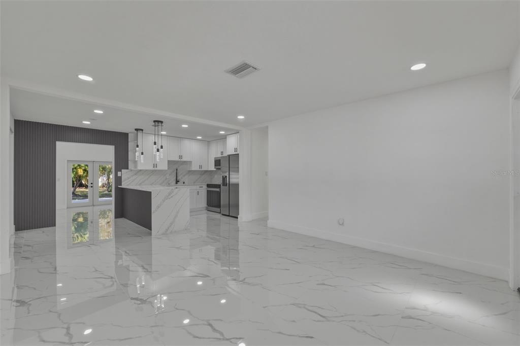 1413 May Street Lutz, FL 33548 - Photo 7 of 43 a view of kitchen with kitchen island a sink white cabinets and stainless steel appliances