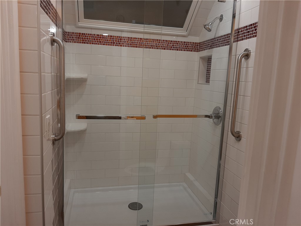 12592 Montecito Road, Unit 9 Seal Beach, CA 90740 - Photo 12 of 16 a bathroom with a glass shower door
