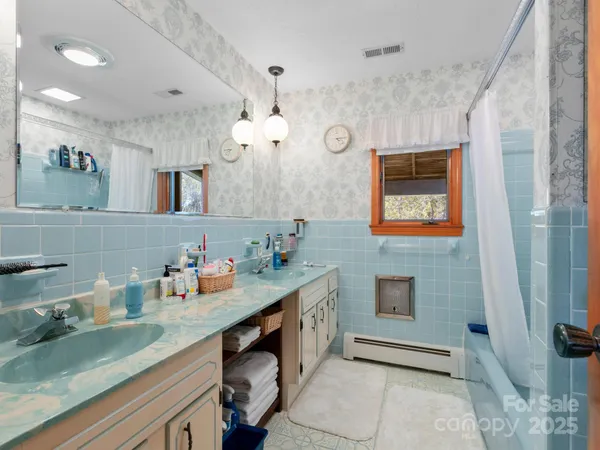 a bathroom with a sink vanity and a mirror