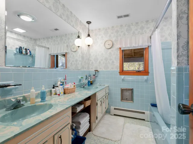 a bathroom with a sink vanity and a mirror