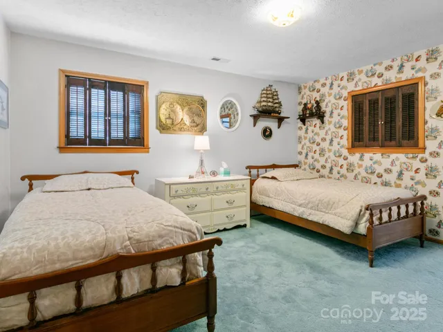 a living room with furniture a large window and potted plants