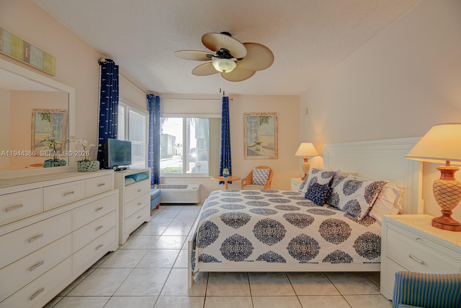 326 Harrison Street, Unit 106A Hollywood, FL 33019 - Photo 1 of 22 a bedroom with double bed and a large mirror