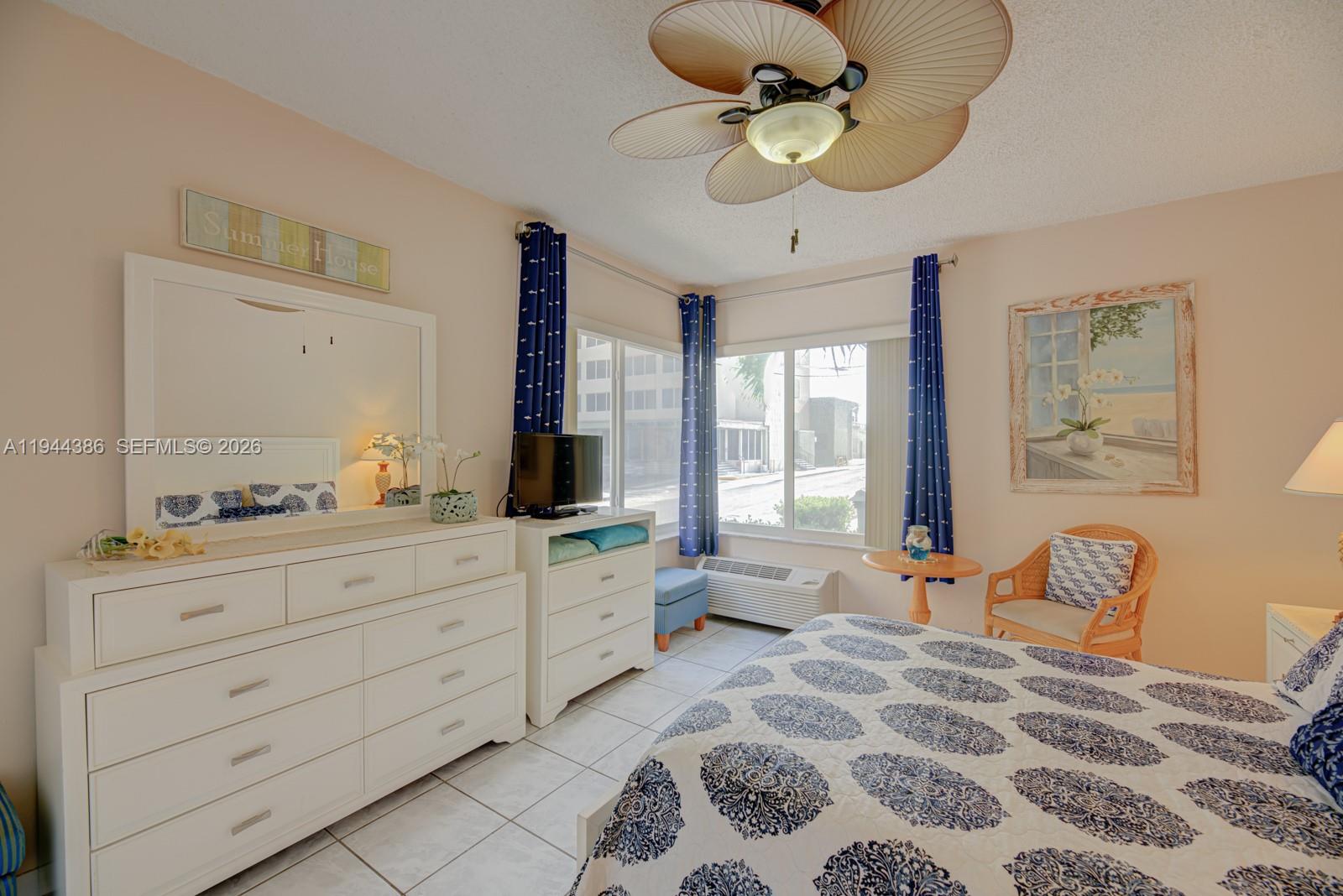 326 Harrison Street, Unit 106A Hollywood, FL 33019 - Photo 12 of 22 a bedroom with a bed dresser and wooden floor