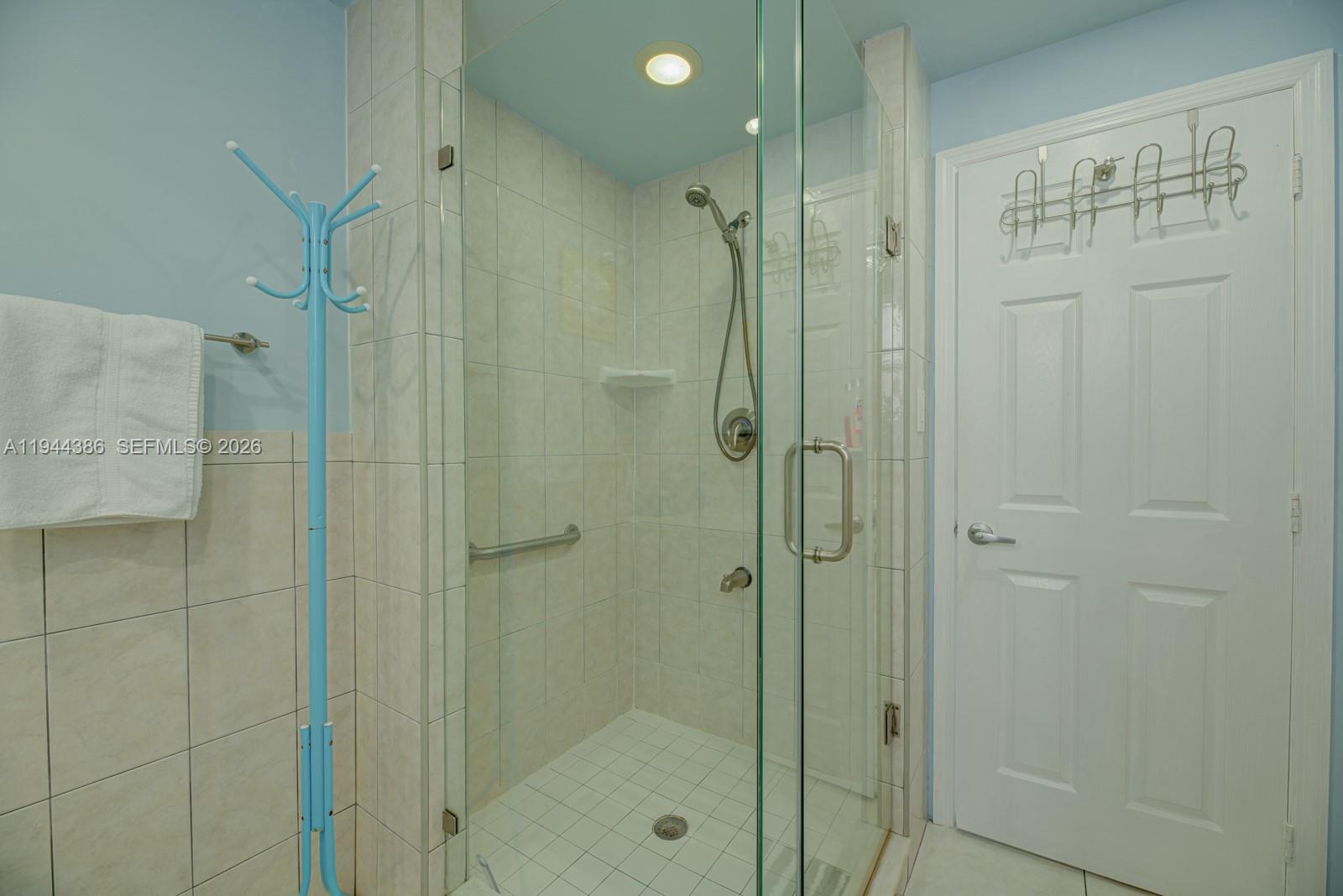 326 Harrison Street, Unit 106A Hollywood, FL 33019 - Photo 13 of 22 a bathroom with a shower and a glass door