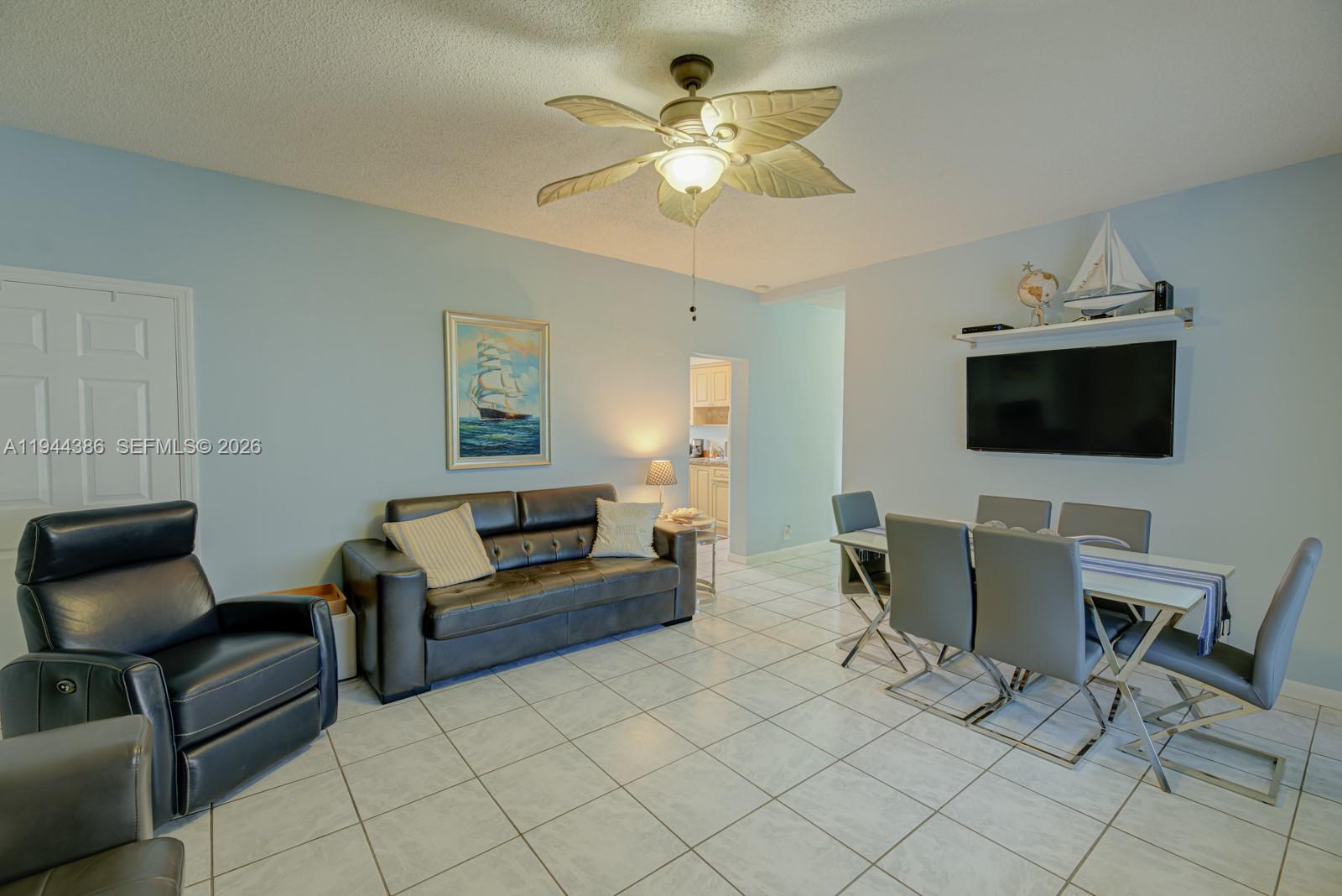 326 Harrison Street, Unit 106A Hollywood, FL 33019 - Photo 17 of 22 a living room with furniture and a flat screen tv