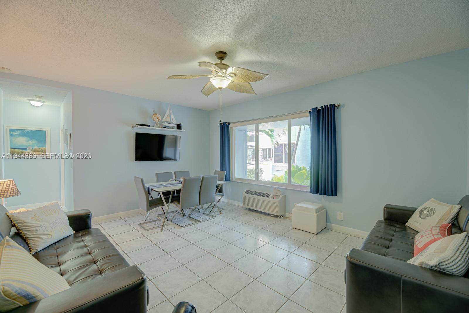 326 Harrison Street, Unit 106A Hollywood, FL 33019 - Photo 18 of 22 a living room with furniture and a flat screen tv