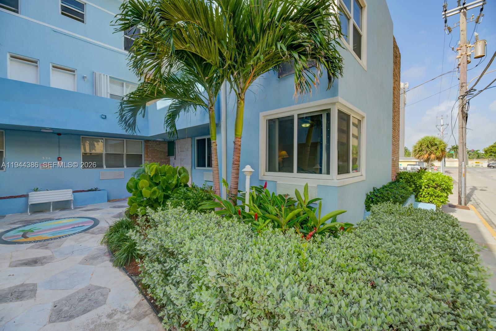 326 Harrison Street, Unit 106A Hollywood, FL 33019 - Photo 22 of 22 a front view of a house with garden