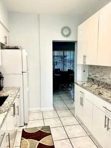 a kitchen with a sink a stove and a refrigerator