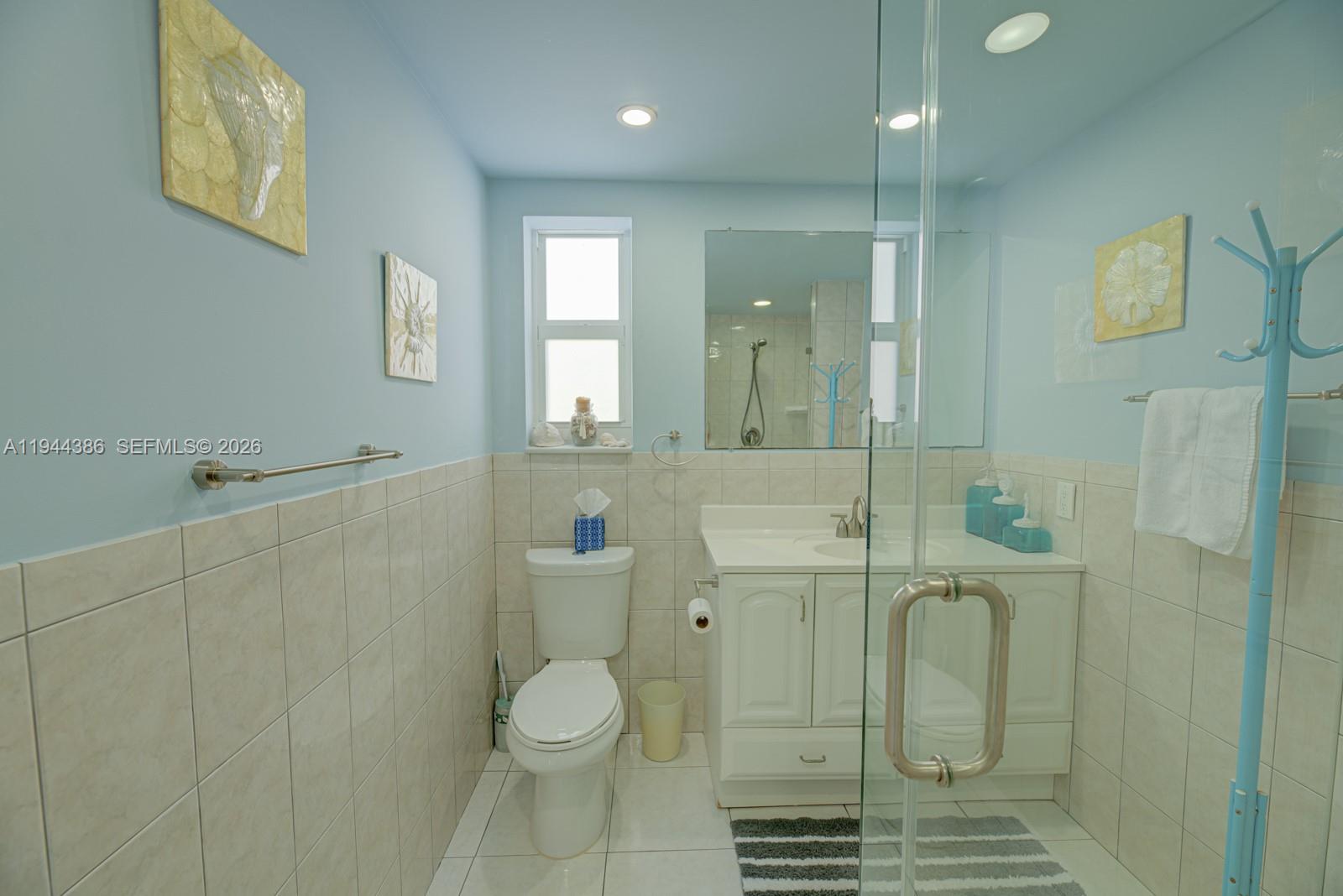 326 Harrison Street, Unit 106A Hollywood, FL 33019 - Photo 4 of 22 a bathroom with a sink a toilet and shower