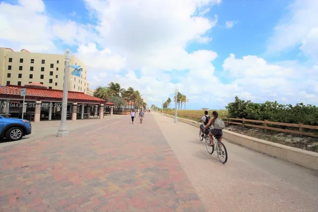 a view of a white house with swimming pool and sitting area