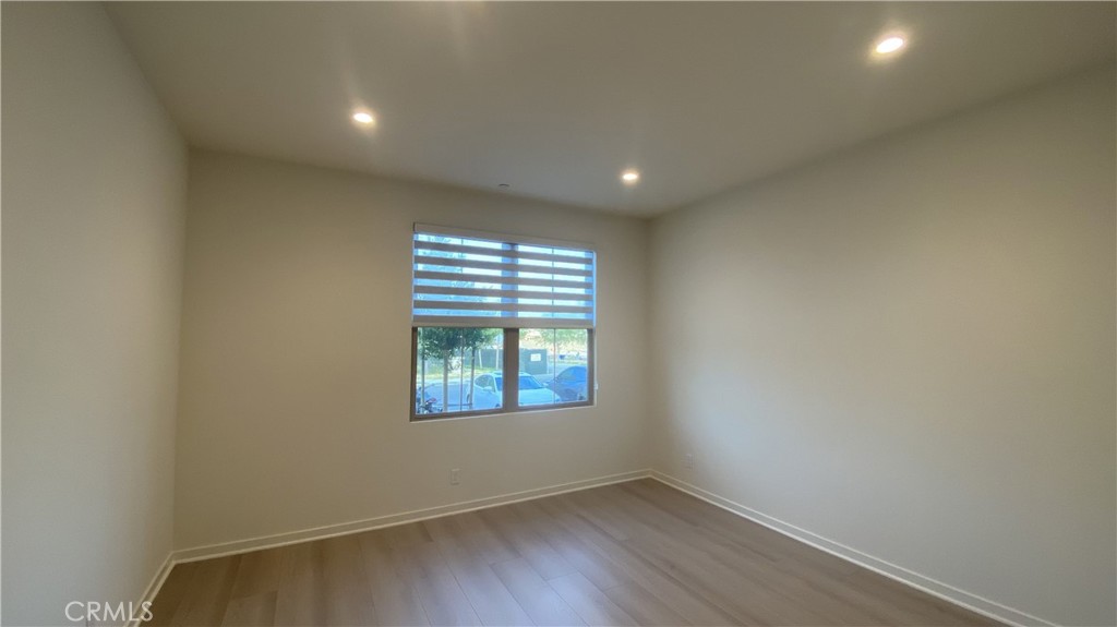 110 Sunnyside Irvine, CA 92618 - Photo 11 of 30 an empty room with wooden floor and windows