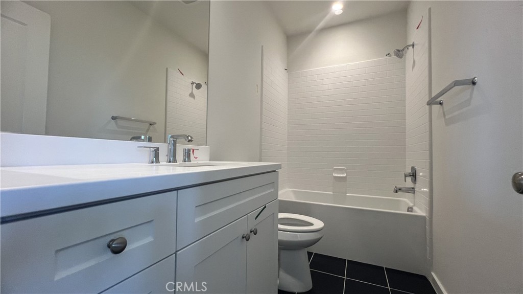 110 Sunnyside Irvine, CA 92618 - Photo 14 of 30 a bathroom with a sink a toilet and shower