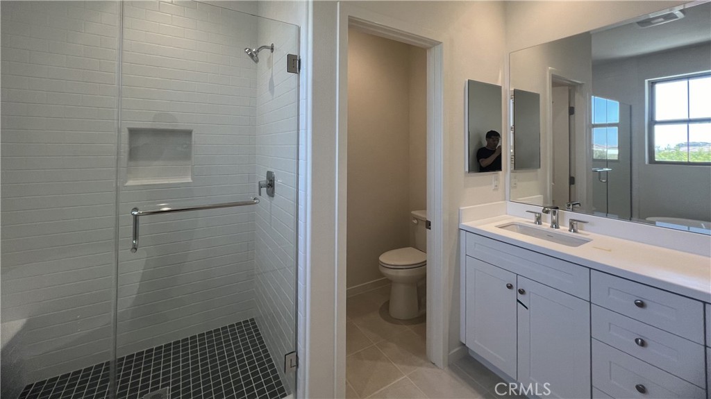 110 Sunnyside Irvine, CA 92618 - Photo 22 of 30 a bathroom with a sink a toilet and shower