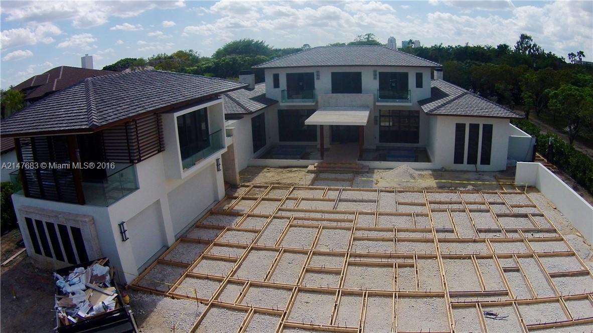 9000 Southwest 63rd Court Pinecrest, FL 33156 - Photo 13 of 26 a front view of a house with a yard