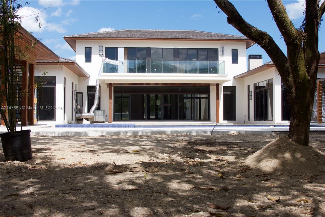 9000 Southwest 63rd Court Pinecrest, FL 33156 - Photo 19 of 26 a view of a white house with a large tree
