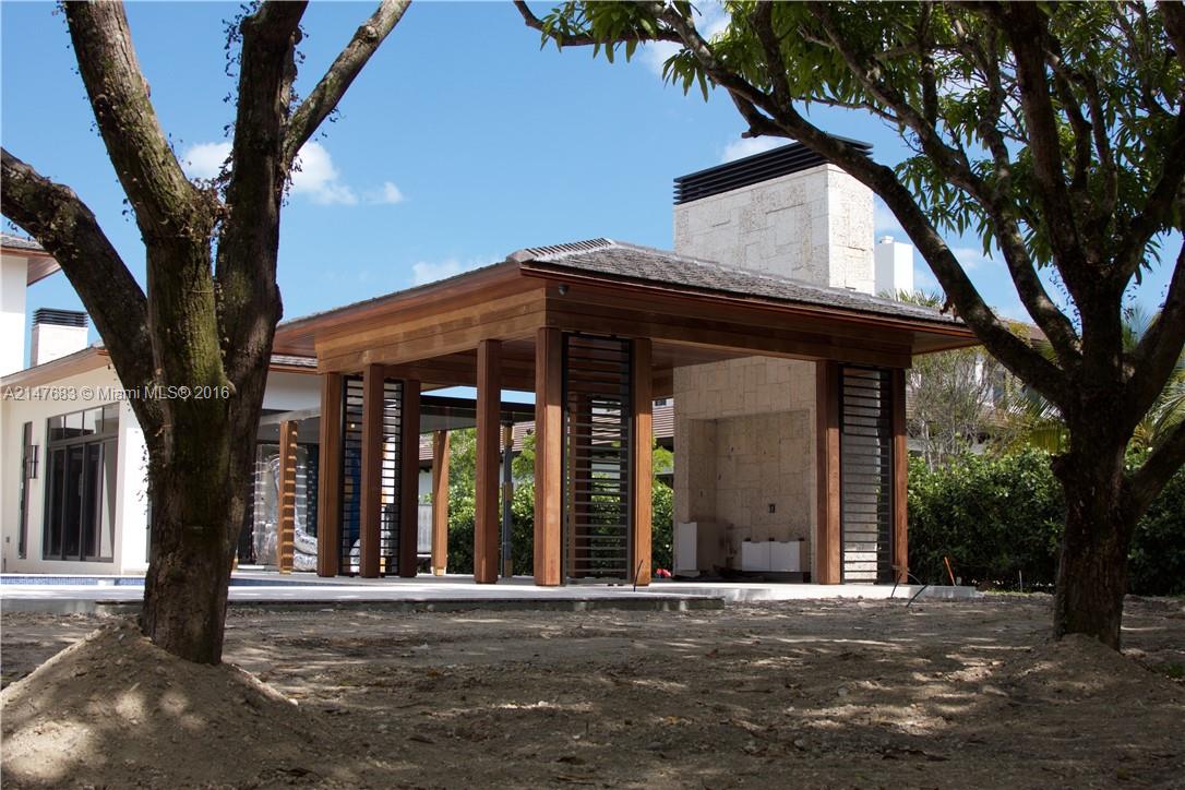 9000 Southwest 63rd Court Pinecrest, FL 33156 - Photo 21 of 26 a front view of a house with a tree